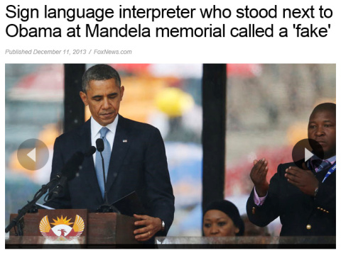 Fake interpreter standing behind scumbag Barack Obama
