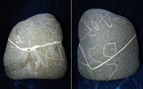 A stone artifact with a drawing of a world map with an inlay of the All Seeing Eye. The location where this artifact was found is also marked on the map with an inlay (circled with green)